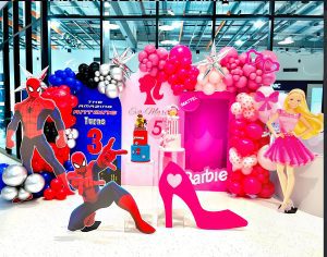 Spiderman and Barbie joint birthday party styling with themed props, colourful backdrops and balloon garland by Colourful Treasures