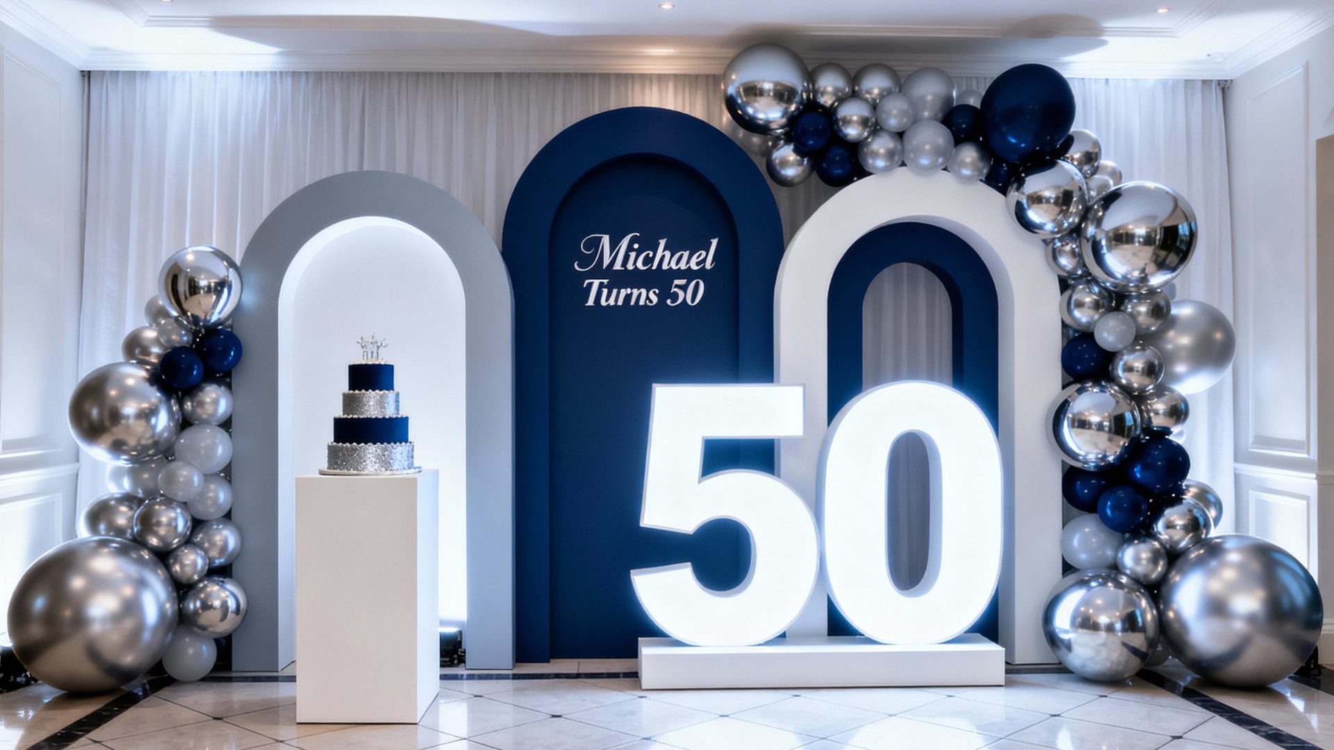 50th milestone birthday styling with metallic silver and navy balloons and arched props by Colourful Treasures
