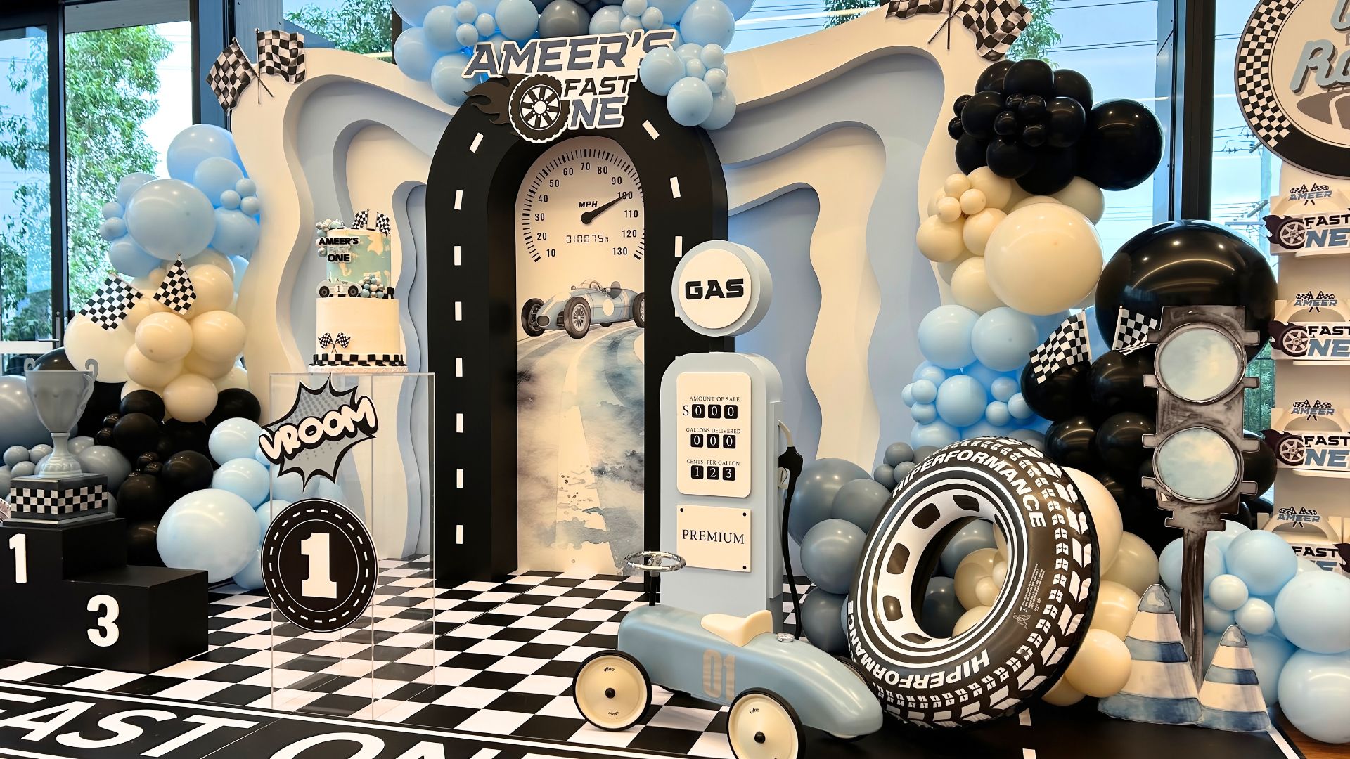 fast one first birthday backdrop with balloons and decorations by colourful treasures